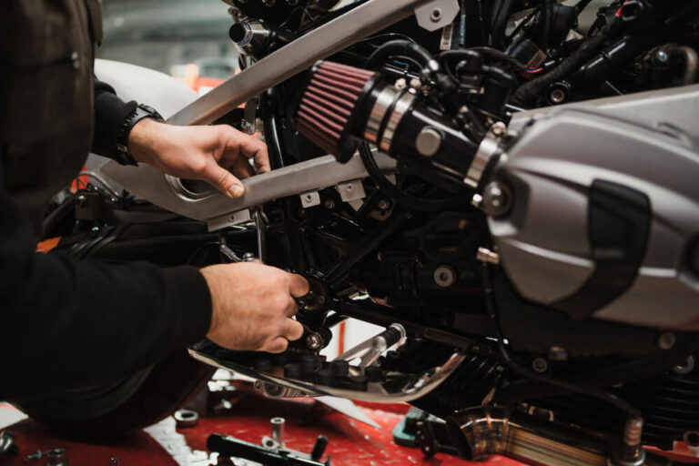 Man fixing motorcycle near Melbourne